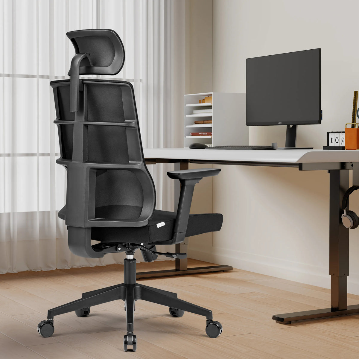 Musta Ammattitason toimistotuoli SPINIO PRO niskatuella ja käsinojilla työpöydän edessä, valmistaja hjh OFFICE